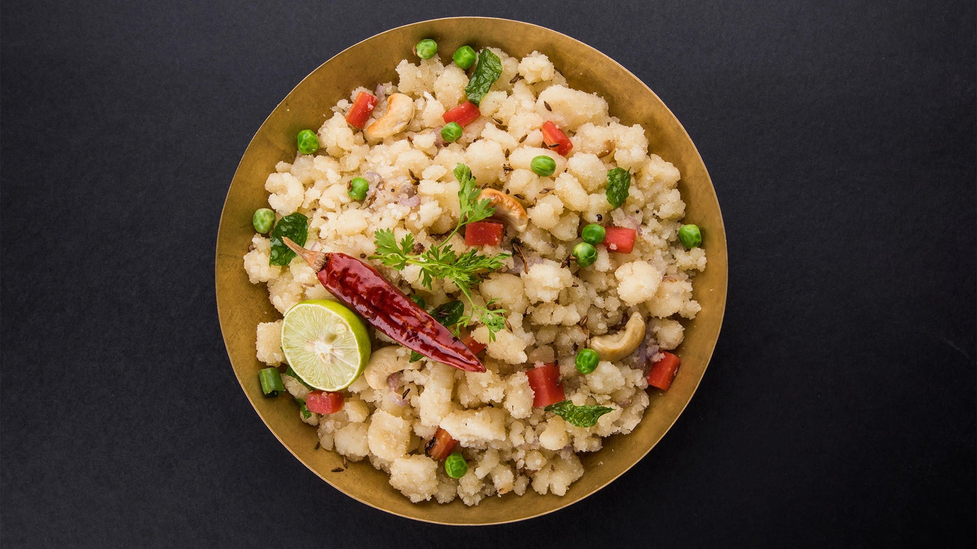 Close-up of a bowl of freshly prepared upma with vegetables. 